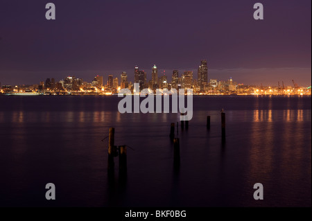Retro image, Seattle skyline from West Seattle at sunrise with silhoutetted pilings along Elliott Bay shoreline Seattle Washington State USA Stock Photo