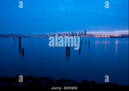 Retro image, Seattle skyline from West Seattle at sunrise with pilings along Elliott Bay shoreline Seattle Washington State USA Stock Photo
