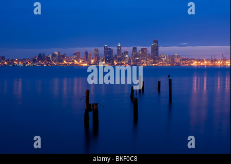Retro image, Seattle skyline from West Seattle at sunrise with silhoutetted pilings along Elliott Bay shoreline Seattle Washington State USA Stock Photo