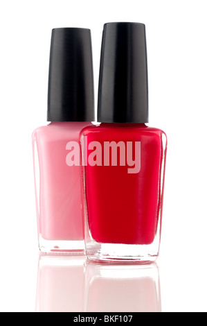 vertical image of red and pink nail polish on a white reflective surface Stock Photo