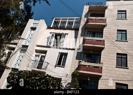 upper facade white stucco Art Deco apartment building & later wannabe neighbour Avenida Amsterdam Condesa District Mexico City Stock Photo