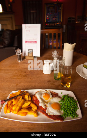 Gammon , eggs , and chips inside The Rushbrooke Arms pub restaurant in Sicklesmere near Bury St Edmunds , Suffolk , England , UK Stock Photo