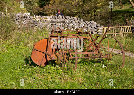 rusty farm machinery in corner of field. Stock Photo