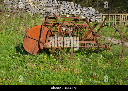 rusty farm machinery in corner of field. Stock Photo