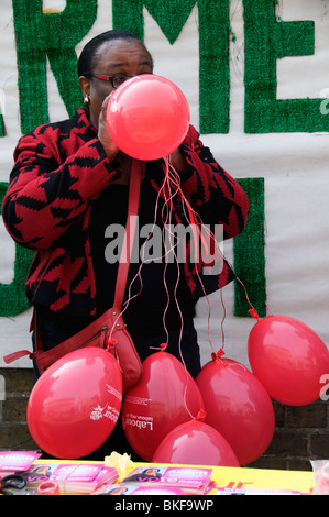 London Hackney General election 2010 Diane Abbot Labour party candidate blowing up red balloons Stock Photo