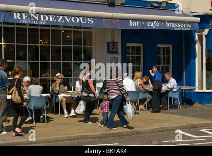 People Relaxing In The Sun at Pavement Tables Of A Cafe Stock Photo