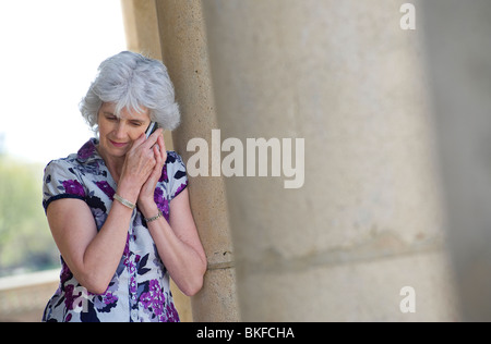 mature female using mobile phone Stock Photo