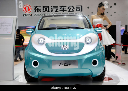 A model poses next to Dongfeng Motor Group Co.'s I-Car concept vehicle, displayed at the Beijing Auto Show 2010. Stock Photo