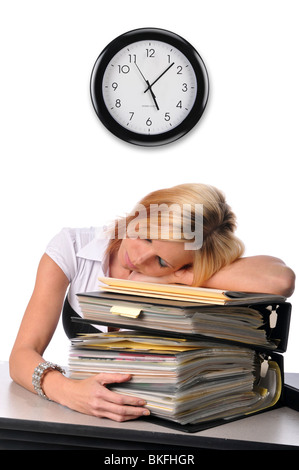 Woman at the office sleeping over a pile of files Stock Photo