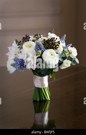 bouquet or posey of spring flowers including ranunculus, daffodil, muscari, hedera Stock Photo