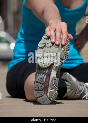 young woman stretching before running Stock Photo