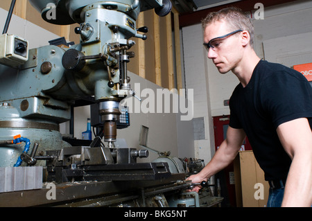 A precision engineer in his workshop using a milling machine wearing safety glasses. Stock Photo