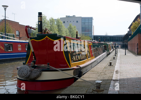 Traditional narrowboat with bright red and green livery painted on ...