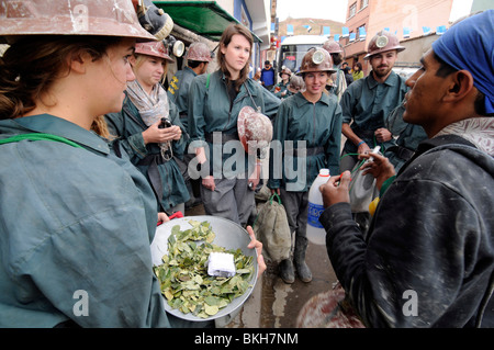 Tourists dressed buying gifts for miners (drinks, coca leaves) before visiting the  mines of the Cerro Rico in Potosi, Bolivia. Stock Photo