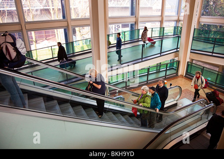People on ramp and escalator at Gatwick airport England UK Stock Photo