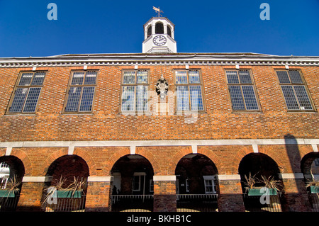 Horizontal wide angle view of the prominent red brick Market Hall in Old Amersham High Street on a sunny day. Stock Photo