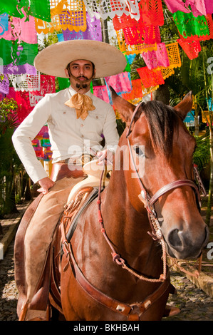 Guadalajara, Mexico, Charro (Mexican Cowboy) riding horse down cobblestone street, Club Charro Lienzo, Jalisco Stock Photo