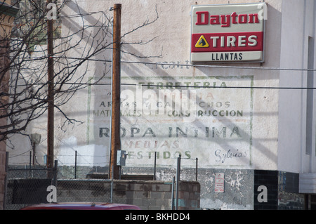 Wall ads in the Golden Horse Shoe District in El Paso, Texas. New style is the neon one, old style is painted as mural on wall Stock Photo