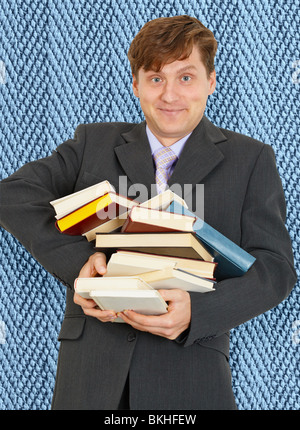 Funny guy with an armful of books and textbooks Stock Photo