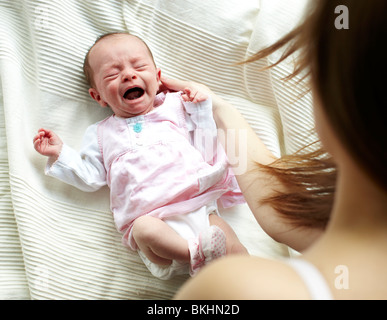 Worried Teenage Girl With Crying Newborn Baby In Hospital Stock Photo