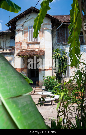 A good example of French Colonial Architecture with Banana Plants, Vientiane, Laos, Indochina Stock Photo