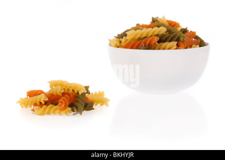 Tricolore fusilli pasta in a bowl isolated on a white background Stock Photo