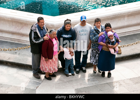 four generations of a Mexican family pose proudly in front of fountain in courtyard of National Palace on Mexico City Zocalo Stock Photo