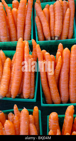 Freshly picked organic carrots on display at farmer's market Stock Photo