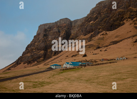 Farm in  South Iceland in the winter with mountains behind Stock Photo