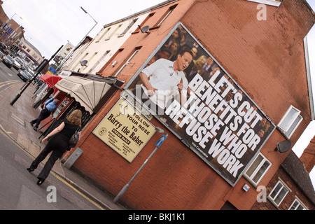 Vote Conservative Tory campaign billboard poster featuring David Cameron saying lets cut  benefits for those who refuse work Stock Photo