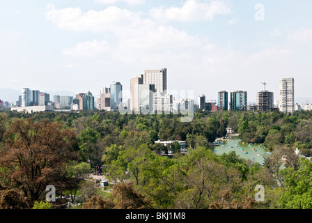 Mexico City skyline seen from Chapultepec Castle looking across Chapultepec Park & people boating on Lago Chapultepec Stock Photo