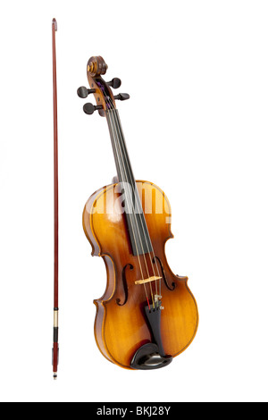 Antique violin with bow next to it, isolated on white background Stock Photo