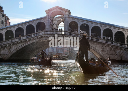 Gondolas passing underneath the Rialto Bridge on the Grand Canal in Venice, Italy Stock Photo