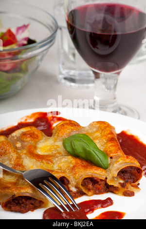 traditional cannelloni pasta dish with tomato sauce Stock Photo