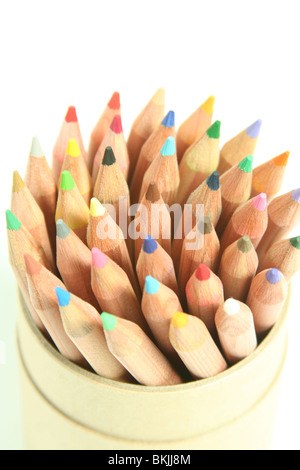 Colourful pencil crayons sat in a tub, pointing upwards in a spiral pattern Stock Photo
