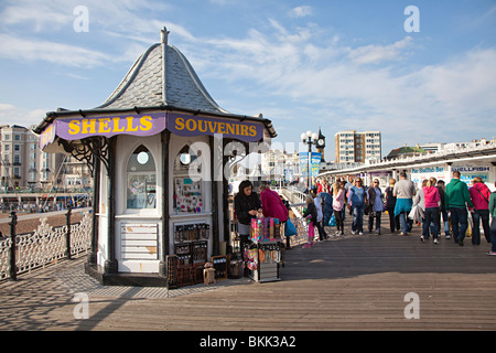 People on Brighton pier with shell and souvenir stand England UK Stock Photo