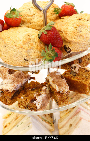 cake stand with Strawberries and scones, Walnut cake sponge, ham and egg sandwiches desert Wedding breakfast table Rufford wedding facilities, Rufford Mill Stock Photo