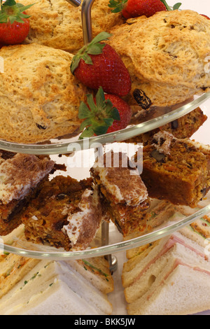 cake stand with Strawberries and scones, Walnut cake sponge, ham and egg sandwiches desert Wedding breakfast table Rufford wedding facilities, Rufford Mill Stock Photo