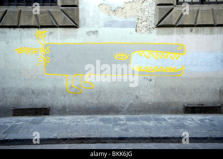 yellow cartoon monster drawing on wall in Florence, Italy Stock Photo