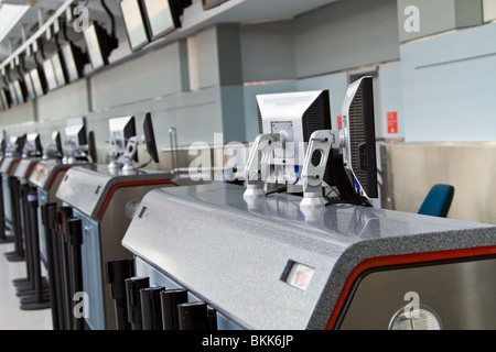 A lineup of check-in counters with LCD screens, both on the counters and above, at Pearson International Airport, Toronto. Stock Photo