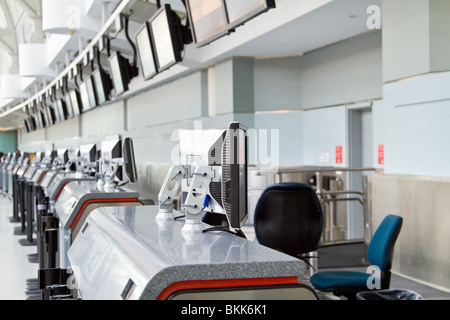 A lineup of checkin-counters with LCD screens, both on the counters and above, at Pearson International Airport, Toronto. Stock Photo
