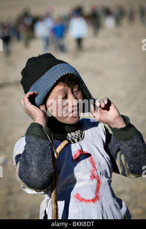 Small rider after horse riding competition at the yearly Golden Eagle festival in Bayan Olgii, Western Mongolia. Stock Photo