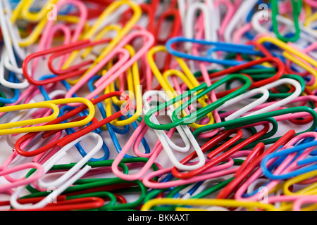 multicolored paperclips on a white background Stock Photo