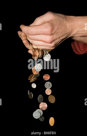 42 yr old caucasian male hands with money falling depicting concept of money slipping through hands or too much money to hold Stock Photo