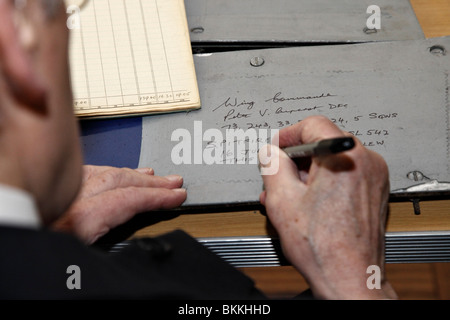 Veteran World War Two Spitfire pilot Peter Ayerst signing a piece of recovered fuselage. Stock Photo