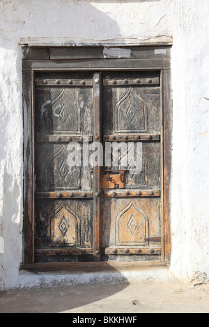 old wooden door in the village of Sur, Sultanat of Oman. Photo by Willy Matheisl Stock Photo