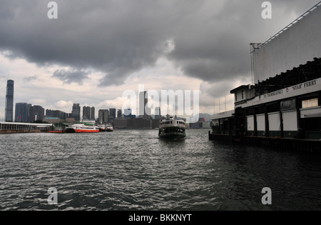 Star Ferry, against the dark sky of a Kowloon backdrop, approaching the Wan Chai Ferry Terminal, Victoria Harbour Hong Kong Stock Photo