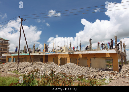 Kenya, wrecking building by hand with hammer, man demolish construction Stock Photo