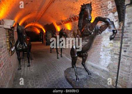 Horse statues in The Stables at Camden Market shopping complex interior old historical Pickfords horses stable yard Camden Town London England UK Stock Photo