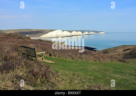 Bench on Seaford Head over looking Cuckmere Haven and the chalk cliffs of the Seven Sisters, East Sussex England UK Stock Photo